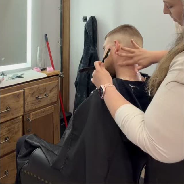 Kait giving a client a straight razor neck finish